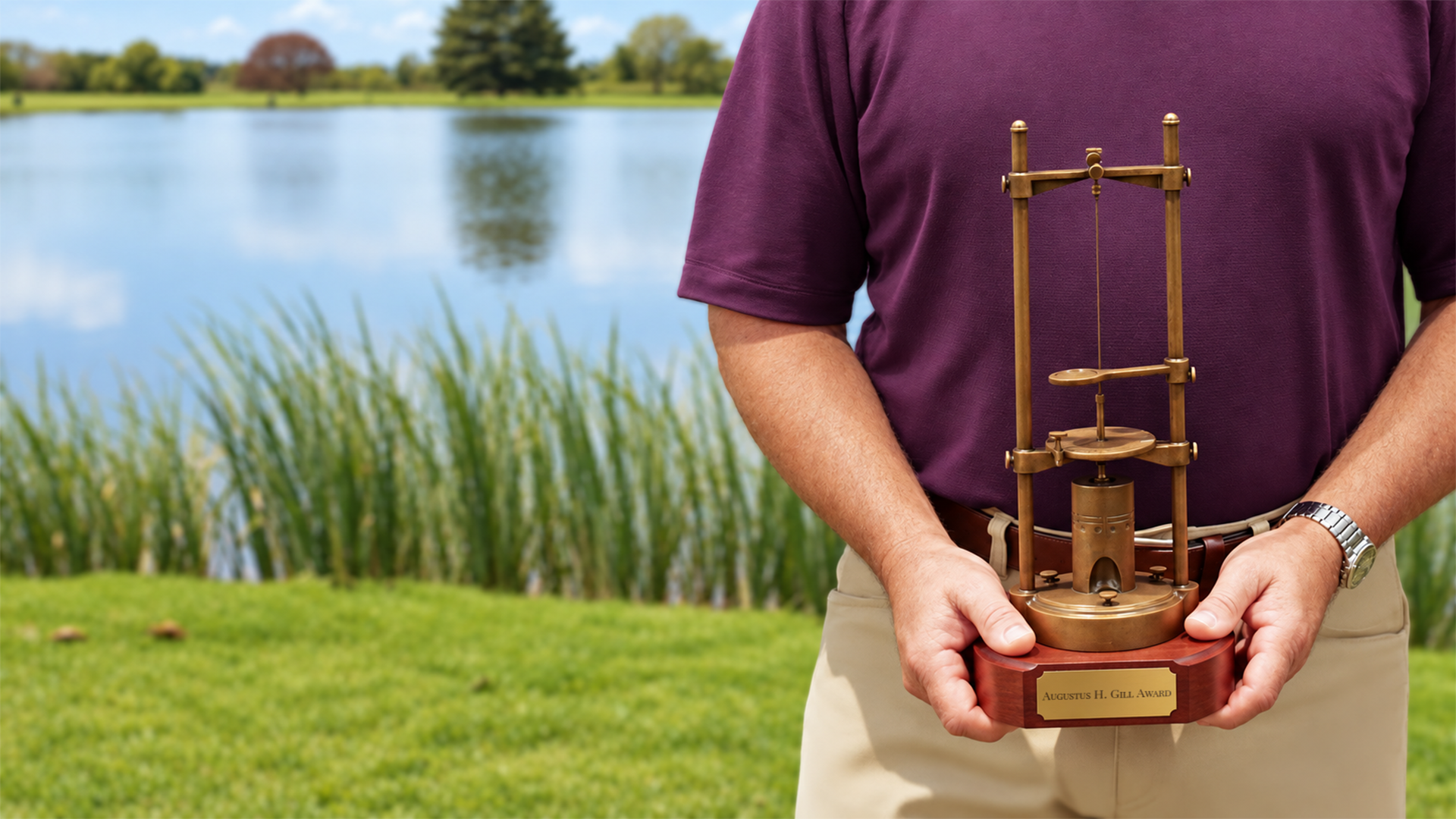An ICML award recipient holding the Gill Award trophy